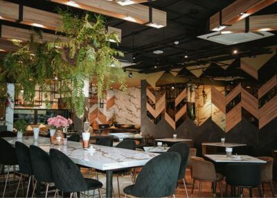 Modern restaurant interior with wooden design elements and plants