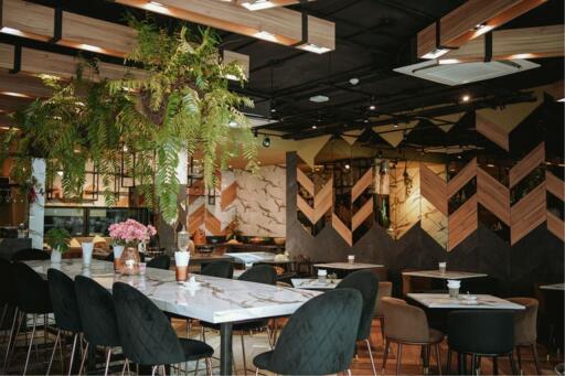 Modern restaurant interior with wooden design elements and plants