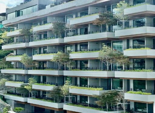 Modern apartment building with balconies and greenery