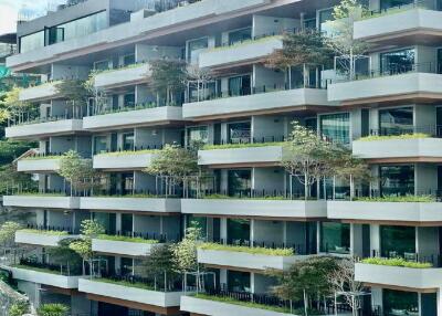 Modern apartment building with balconies and greenery
