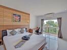 Spacious bedroom with modern design, large bed, and a beautiful view