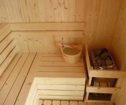 Cozy wooden sauna with benches and stones