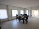 Spacious, well-lit living room with large dining table