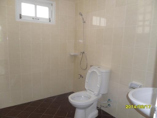Modern tiled bathroom with toilet and shower