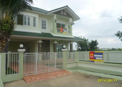 Two-story house with balcony and gated entrance, For Sale sign visible