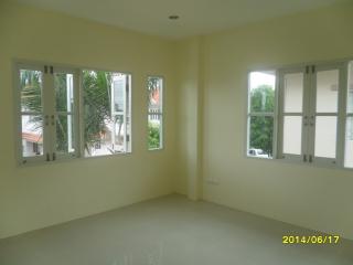 Bright and spacious unfurnished bedroom with large windows