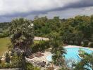 Common area with pool and landscaping under a cloudy sky