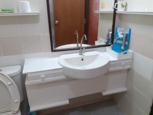 Modern bathroom with white fixtures including sink and toilet