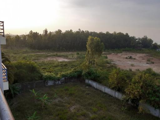 View of a vacant lot from a nearby building at dusk