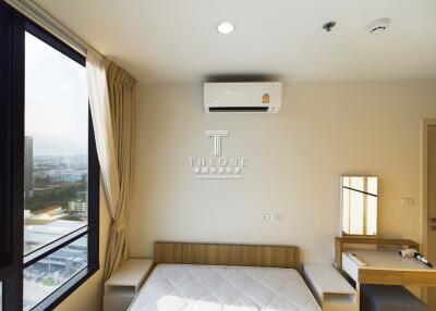 Modern bedroom with large window and air conditioning