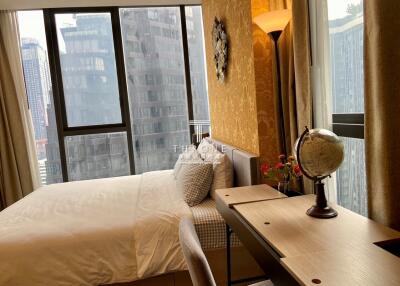 Cozy bedroom with large window and city view