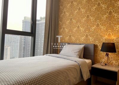 Cozy bedroom with stylish wallpaper and city view