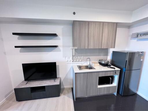 Modern compact kitchen with appliances and shelves