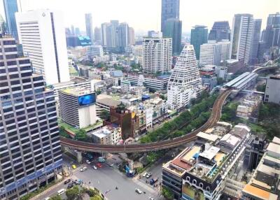 Aerial view of a modern urban cityscape with tall buildings and an elevated railway