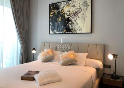 Modern bedroom with cozy bed and abstract art