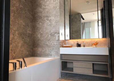 Modern bathroom with bathtub and large mirror