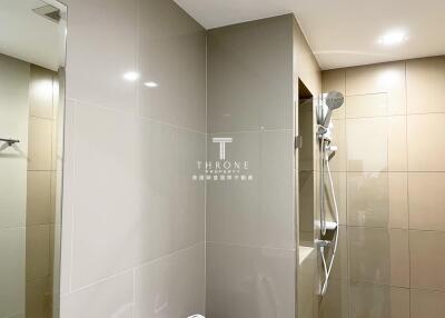 Modern bathroom with tiled walls and shower area