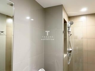 Modern bathroom with tiled walls and shower area