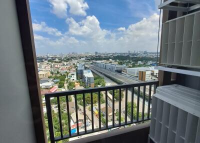 View from balcony with shelf unit and cityscape