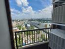 View from balcony with shelf unit and cityscape