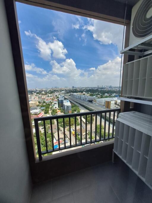 View from balcony with shelf unit and cityscape