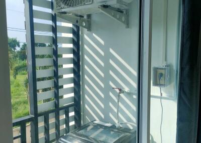 Balcony with washing machine and air conditioning unit