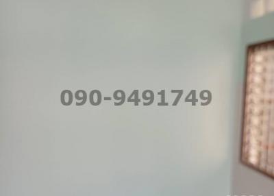 Blurred interior image with a contact number and QR code