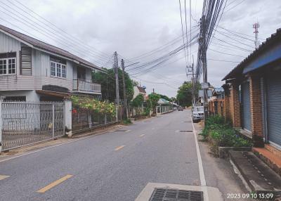 Residential street view with multiple houses and overcast sky