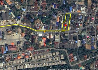 Aerial view of property layout with marked boundaries on a sunny day