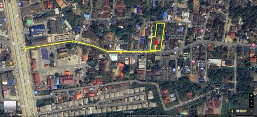 Aerial view of property layout with marked boundaries on a sunny day