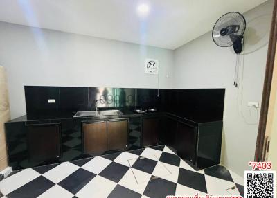 Modern kitchen with black cabinetry and checkered floor