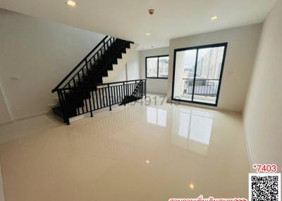 Spacious and bright living room with stairs and access to balcony