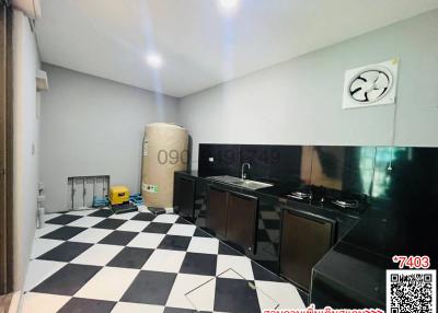 Compact modern kitchen with black and white checkered floor, integrated appliances, and air conditioning unit