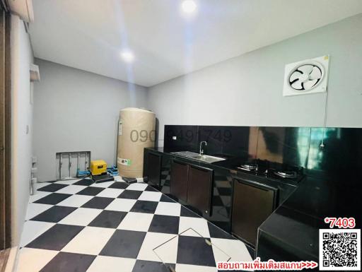 Compact modern kitchen with black and white checkered floor, integrated appliances, and air conditioning unit