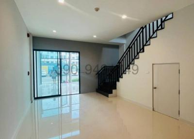 Spacious and bright interior space with a staircase and large window