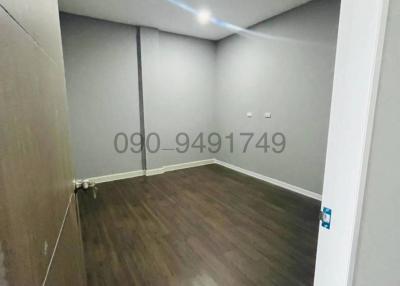 Empty room with wooden flooring and white walls