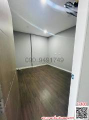 Empty room with wooden flooring and white walls