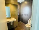 Compact modern bathroom with tiled walls and flooring