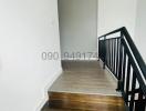 Modern staircase in a home with wooden steps and black railings
