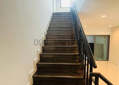 Wooden staircase with metal railing in a modern home