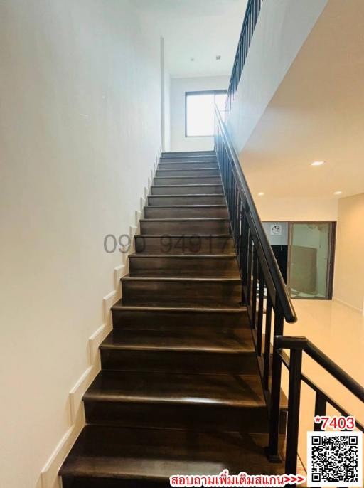 Wooden staircase with metal railing in a modern home