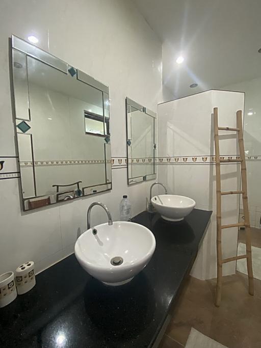 Modern bathroom with double vanity and large mirrors