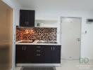 Modern kitchen with mosaic backsplash and stainless steel hood