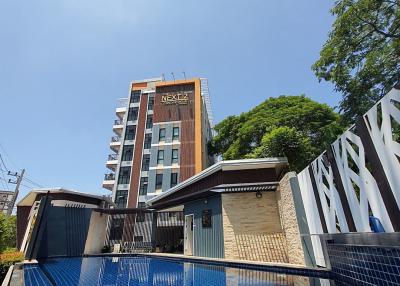 Modern residential building with swimming pool under clear blue sky