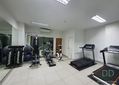 Spacious home gym with various fitness equipment