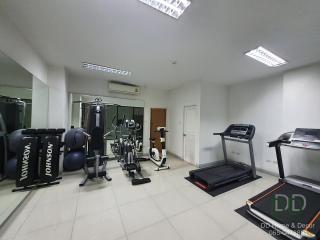 Spacious home gym with various fitness equipment