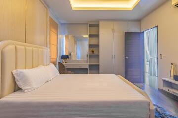Modern bedroom interior with king-sized bed and en-suite bathroom