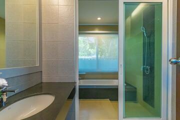 Modern bathroom with tub and separate glass-enclosed shower