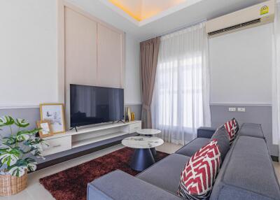 Modern living room interior with comfortable sofa and flat-screen TV