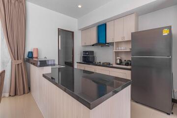Modern kitchen with stainless steel appliances and breakfast bar